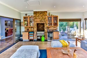 a living room with a couch and a table at RR001 Robbins Road - A home away from home in Ballito