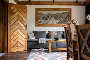 a living room with a couch and a table at Willa Polana pod Nosalem in Zakopane