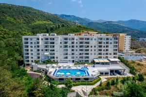 an apartment building with a swimming pool and a resort at Status-M Аpartments 173 in Bečići