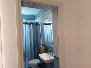 a bathroom with a sink and a toilet and a mirror at APARTMAN I SOBE MARIJANA in Rab +48 photos