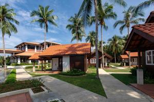 a row of houses with palm trees at Adena Beach Resort in Kuantan +43 photos