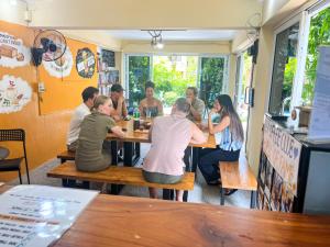 a group of people sitting at tables in a restaurant at Amy Village Apartments & Digital Hub in Lamai