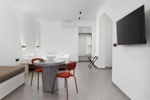 a living room with a table and two chairs at Spanos Apartments in Agios Petros