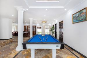 a pool table in a living room with columns at Villa Luxury Hồ Bơi Bãi Sau Vũng Tàu in Vung Tau