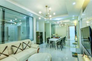 a living room with a couch and a table with chairs at KING Hotel in Vung Tau