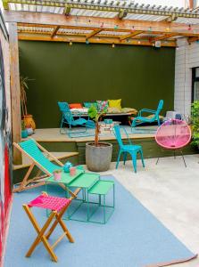 a group of chairs and tables on a patio at Magnifique maison coloniale in Noumea