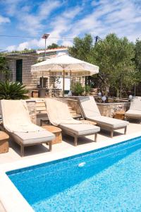 a pool with chaise lounges and a swimming pool at Moya Boutique Sleep in Mali Drvenik