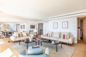 a living room with two couches and a table at Sunset - Vue exceptionnelle sur l'océan in Biarritz