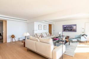 a living room with a couch and a table at Sunset - Vue exceptionnelle sur l'océan in Biarritz