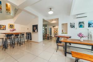 a dining room with tables and chairs in a building at d'Fun 5BR16-24px Pool BBQ NetFlx HotPot KTV Mahjong by Our Stay in Ulu Tiram