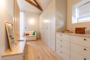 a room with a dresser and a chair in it at Villa Mila - A 450 m de la plage in Biarritz