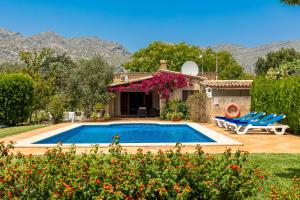 a villa with a swimming pool in a yard at Villa Ca Na Magdalena By homevillas360 in Pollença