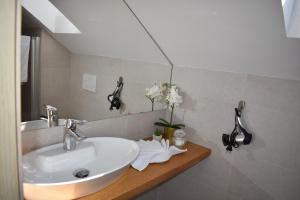 a bathroom with a white sink and a mirror at CoCo Villa in Makarska