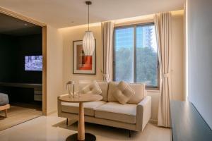 a living room with a couch and a table at Express by M Village Nguyễn Bỉnh Khiêm in Ho Chi Minh City