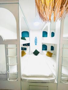 a bedroom with a white bunk bed with blue accents at Homestay mon house quy nhơn-phòng in Quy Nhon