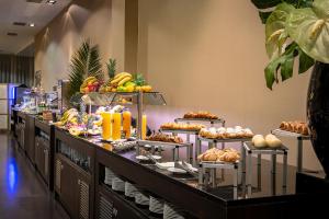 a buffet line with many different types of food at Hotel Diagonal Plaza in Zaragoza