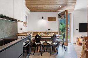 a kitchen with a table and chairs and a dining room at La Casa di Larice in Val di Sole in Rabbi