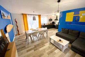 a living room with a couch and a table at Villa Portugal - Domaine Le Sherwood in Notre-Dame-de-Monts