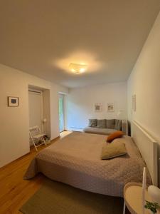 a bedroom with a large bed and a table at Alexa Nida Lighthouse Apartment in Nida