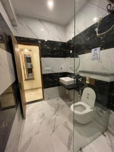 a bathroom with a toilet and a sink at The Amore Hills in Kanatal +55 photos