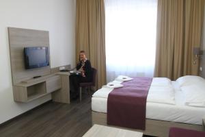TV a/nebo společenská místnost v ubytování Hotel Palác Elektra