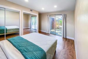 a bedroom with a bed and a large window at Pet & Family-Friendly 4BR Grill & Chill in Sacramento