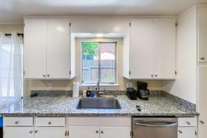a kitchen with white cabinets and a sink and a window at Pet & Family-Friendly 4BR Grill & Chill in Sacramento +24 photos