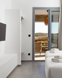 a room with a door leading to a patio at Spanos Apartments in Agios Petros