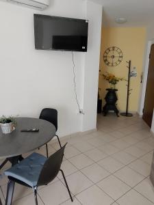 a dining room with a table and a television on a wall at A casa di Giggi in Spoleto
