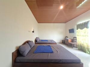 a bedroom with two beds in a room at RedDoorz near Candi Cetho Karanganyar in Karanganyar