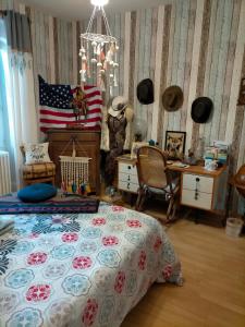 a bedroom with a bed and an american flag at Jadis sous la gloriette in Sancoins