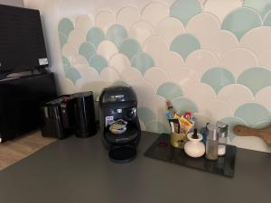 a coffee maker sitting on a counter in a room at Au bon vivre l'appartement in Le Bosc