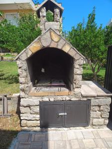 a stone oven with a door in a yard at Apartman Sarah in Kastel Novi