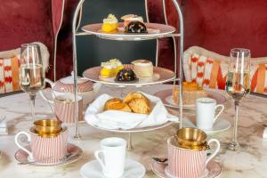 a table with plates of pastries and cups and glasses at The Grand Hotel Birmingham in Birmingham