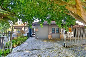 a small house with a fence in front of it at RR001 Robbins Road - A home away from home in Ballito