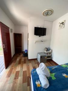 a room with a bed and a tv on the wall at รุ่งเรืองรีสอร์ท3 in Khon Kaen