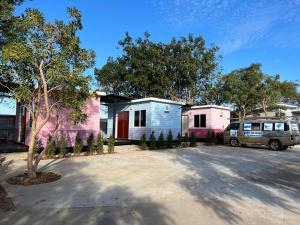 a house and a van parked in a driveway at รุ่งเรืองรีสอร์ท3 in Khon Kaen