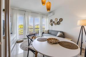 a living room with a white table and chairs at Velipoja Beach Apartment in Velipojë
