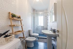 a bathroom with two toilets and a sink at Velipoja Beach Apartment in Velipojë +27 photos