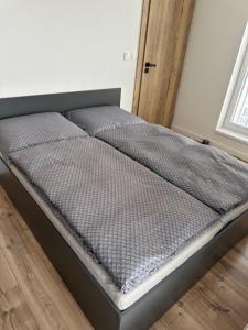 a bed sitting in a room with at Apartment lilly in Poprad