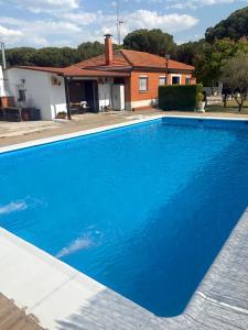 a large blue swimming pool in front of a house at Villa La Espiga in Valladolid +41 photos
