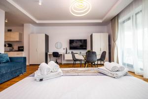 a large living room with a blue couch and a living room at Lilly Studio Axxis Beach in Mamaia