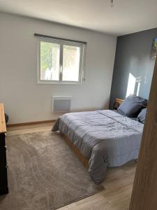 a bedroom with a bed and a window at maison au calme in Maubourguet