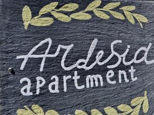 a sign with the words excess artificialarial equipment written on a piece of cloth at Ardesia apartment in Crocetta