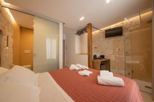 a bedroom with a bed with towels on it at Le Quattro Perle in Monopoli