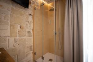 a shower with a glass door in a bathroom at Le Quattro Perle in Monopoli +37 photos