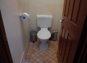 a bathroom with a white toilet in a room at #4 Walpole Wilderness Resort chalet - Spa & Forest! in Walpole