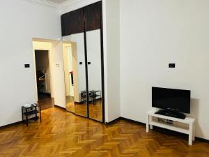 a living room with a television and a mirror at Casa Vacanze Angelina in Trieste +5 photos