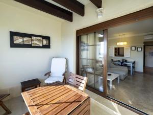 a living room with a table and a living room at Los Pelicanos by Ĥ - Playa Punta del Moral PLHC39P38 in Isla del Moral