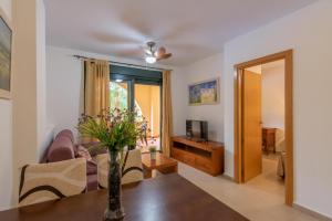 A television and/or entertainment centre at Playa Marina by Ĥ
